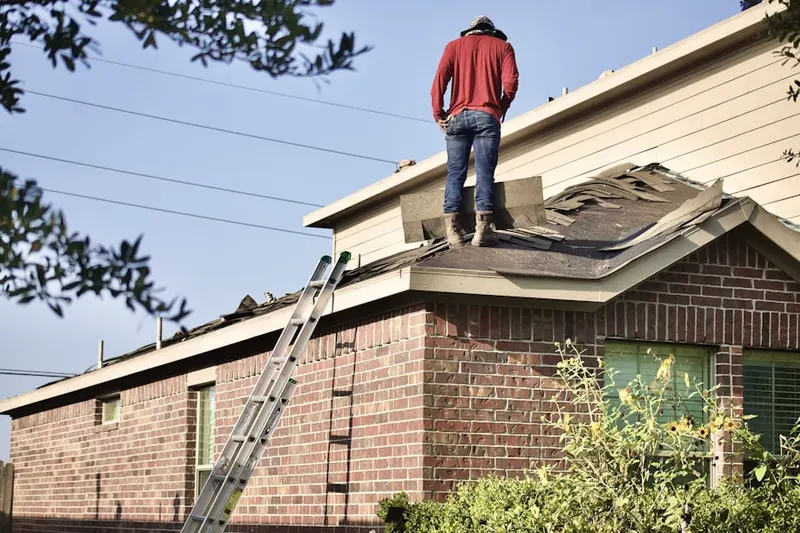 Professional roofer working on a residential roof in Merrill